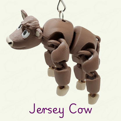 Jersey cow keychain on a beige background.