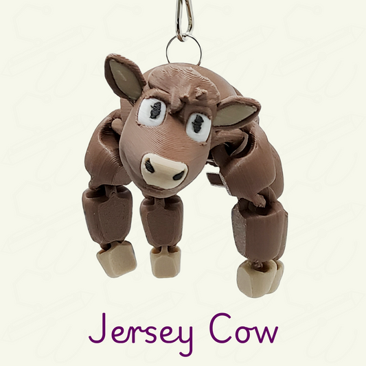A Jersey cow keychian on a beige background with purple 'Jersey Cow' text.