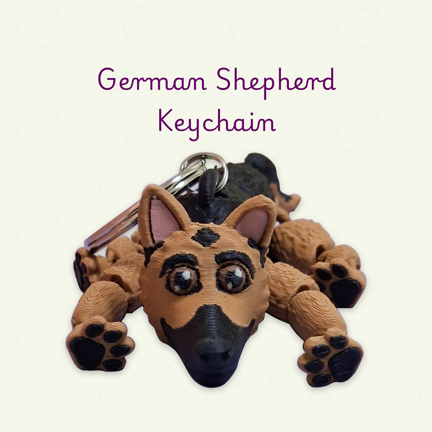 A 3D-printed German Shepherd keychain shaped like the dog lying down, with a metal keyring attached. The keychain is brown with black markings and small pink inner ears. 