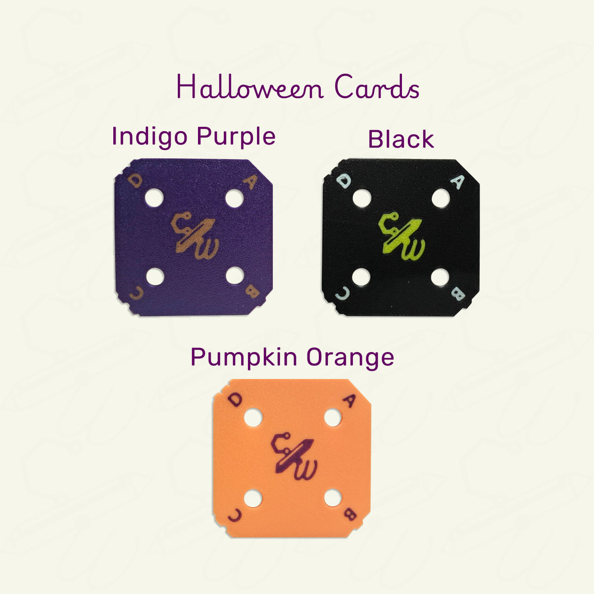 Halloween Weaving Cards on a tan background. Clockwise from top left:  Indigo Purple weaving card with Pumpkin Orange letters and logo, Black weaving card with White letters and Yellow Logo, Pumpkin Orange weaving card with Indigo Purple letters and logo.